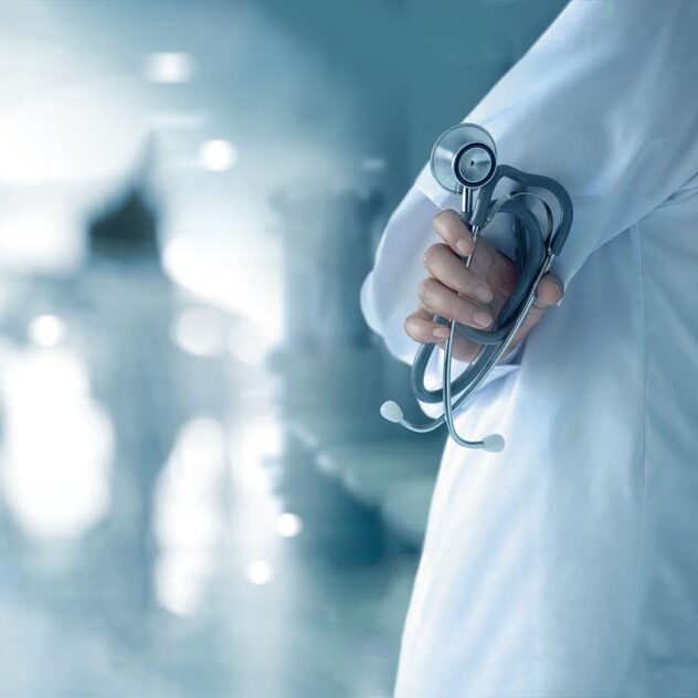 Doctor with stethoscope in hand on hospital background, medical and medicine concept